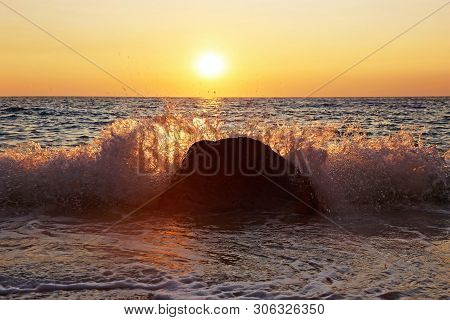 Sunset Scenery Of A Beach At Paxos Ionian Islands Greece - Waves Splash Hitting The Rocks
