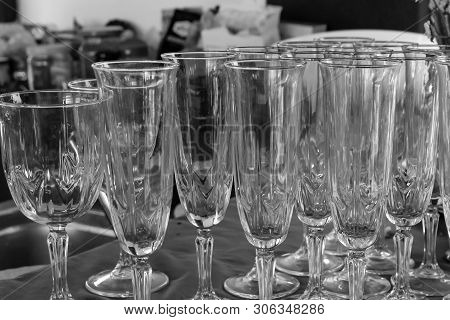 Clean Transparent Glass Of Wine A Lot Of Glasses Festive Dishes. Set Glass Of Champagne Wine Backgro