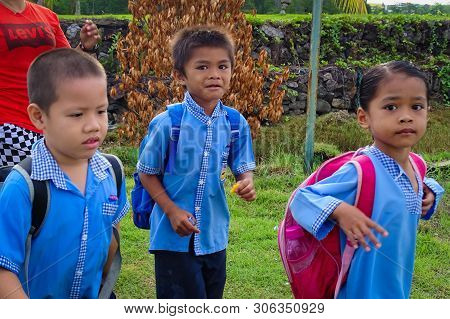 Labuan,malaysia-feb 2,2019:mother And Kids Going To School With Schoolbag In Patau Patau Water Villa