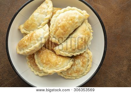Golden Baked Argentinian Meat Empanadas Just Made And Placed In A Bowl