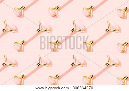 Pattern Made With Pink Massage Tools. Rose Quartz Jade Roller On Pink Background. Anti Age, Lifting 