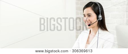 Smiling Beautiful Asian Woman Telemarketing Customer Service Agent Working In Call Center, Panoramic