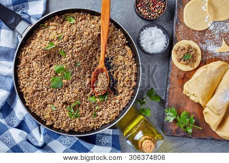 Cooking Pierogies With Ground Liver With Onion Filling Fried In A Skillet, Raw Dough And Uncooked Du