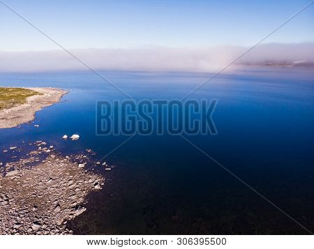 Aerial View. Hardangervidda Mountain Plateau, Norway Landscape. Morning Time, Clouds Over Lake Water