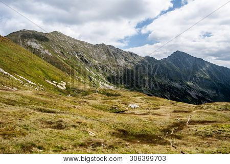Gaborova Dolina Mountain Valley Covered By Mountain Meadow With Peaks Above In Zapadne Tatry Mountai