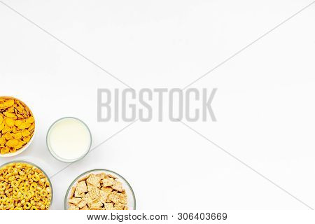 Cereals, Oatflakes And Cornflakes With Milk For Healthy Breakfast On White Background Top View Mock 