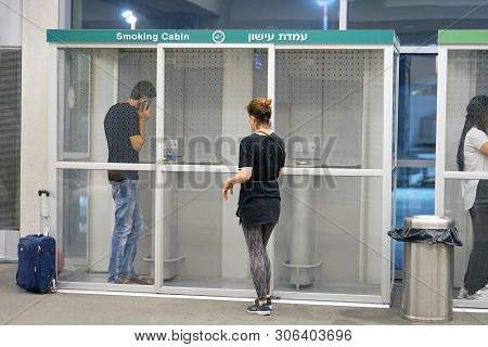Dedicated Small Smoking Room In Modern Airport. Airport Smoking Room Filled With Smokers. The Smokin