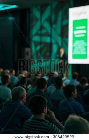 Conference Participants, Events, Presentations, Listen To The Speaker Sitting In Chairs. Rear View O