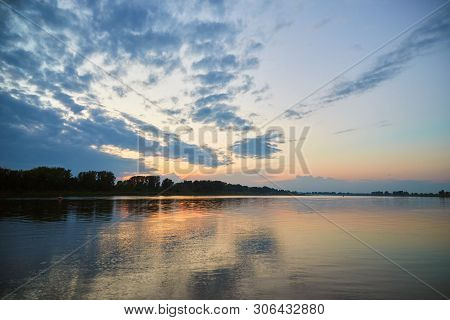 Beautiful Sunset Over The White River With Clouds Reflected In The Water. Bashkiria, Russia