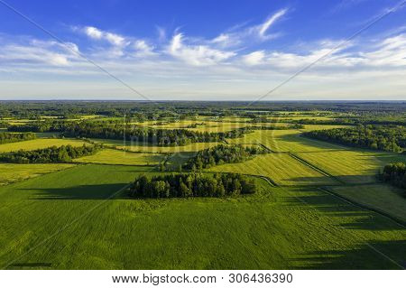 Top Aerial View Of Green Fields And Meadows In Summer. Abstract Landscape With Lines Of Fields, Gras