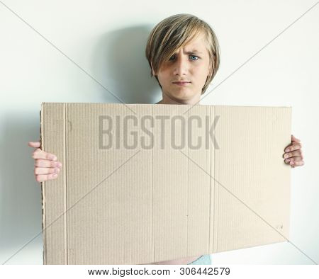 Boy Showing Blank Signboard with Empty Copyspace