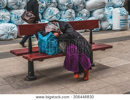 Editorial 27.03.2019 Stockholm Sweden. Romanian Beggar Resting On A Bench With Her Belongings After 