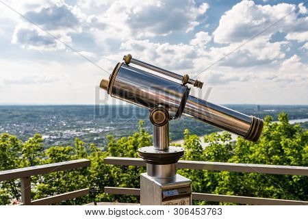 Paid Single Lens Telescope, Set On A High Vantage Point With A View Of The City.