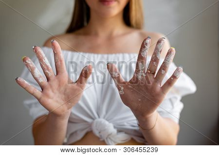 Portrait Of A Girl In A White Shirt That Shows Soiled Hands In White Putty