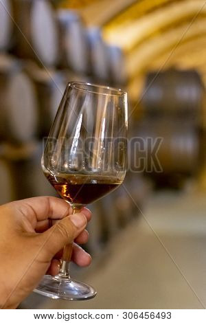 Tasting Of Fortified Dry Or Sweet Marsala Wine In Vintage Wine Cellar With Old Oak Barrels In Marsal