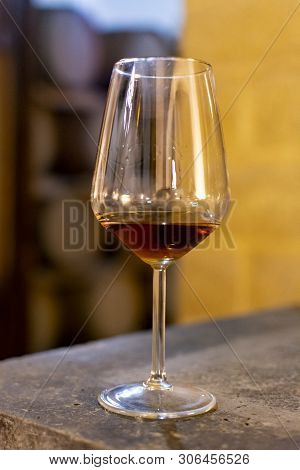 Tasting Of Fortified Dry Or Sweet Marsala Wine In Vintage Wine Cellar With Old Oak Barrels In Marsal