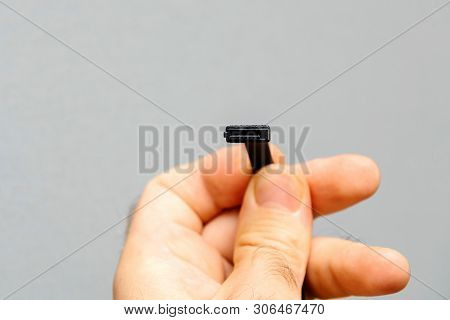 Computer Repairman Engineer Holding New Black S-ata Data Cable Used To Connect Hdd Hard Disk Drive O