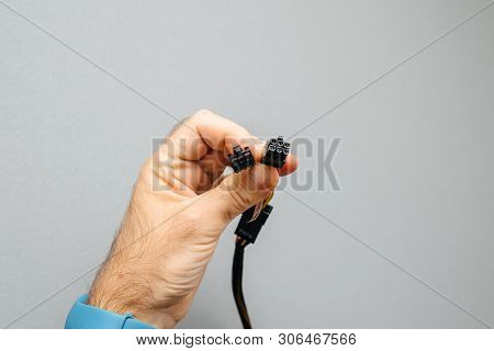 Male Hand It Worker Holding New Power Adapter Cable Dongle Splitter Against Gray Background - Cable 