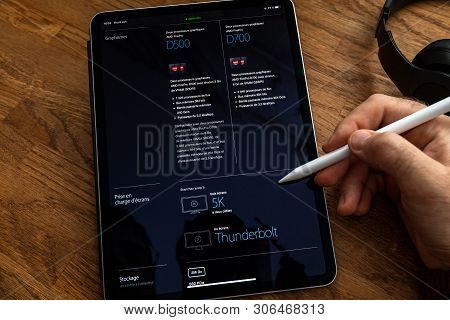 Paris, France - Jun 6, 2019: Man Reading On Apple Ipad Pro Tablet About Powerful Professional Workst