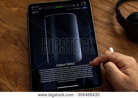 Paris, France - Jun 6, 2019: Man Reading On Apple Ipad Pro Tablet About Powerful Professional Workst