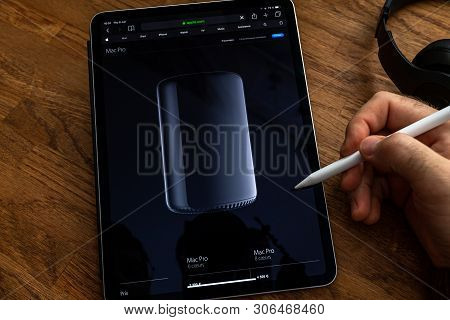 Paris, France - Jun 6, 2019: Man Reading On Apple Ipad Pro Tablet About Powerful Professional Workst