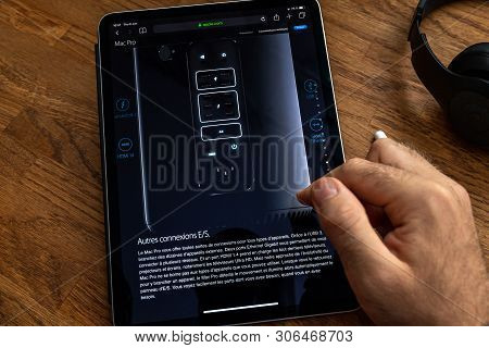 Paris, France - Jun 6, 2019: Man Reading On Apple Ipad Pro Tablet About Powerful Professional Workst