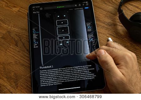 Paris, France - Jun 6, 2019: Man Reading On Apple Ipad Pro Tablet About Powerful Professional Workst