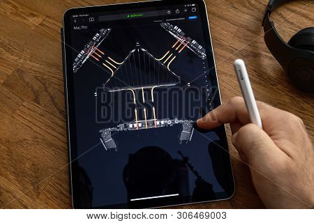 Paris, France - Jun 6, 2019: Man Reading On Apple Ipad Pro Tablet About Powerful Professional Workst