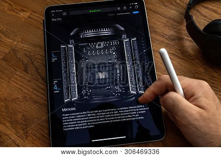 Paris, France - Jun 6, 2019: Man Reading On Apple Ipad Pro Tablet About Powerful Professional Workst