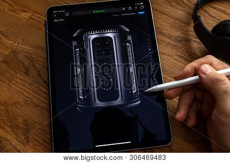 Paris, France - Jun 6, 2019: Man Reading On Apple Ipad Pro Tablet About Powerful Professional Workst