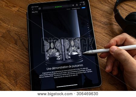 Paris, France - Jun 6, 2019: Man Reading On Apple Ipad Pro Tablet About Powerful Professional Workst
