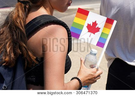 The Annual Parade Lgbt. Girl Lesbian Walking In The Gay Pride Parade. Rainbow Flags At Gay Pride Par
