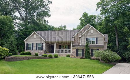 Gray Stone Split-level House in Wooded Setting