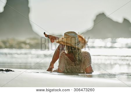 young woman relaxing on the beach in summer day