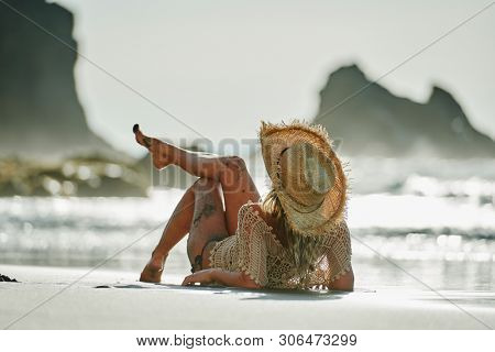 young woman relaxing on the beach in summer day