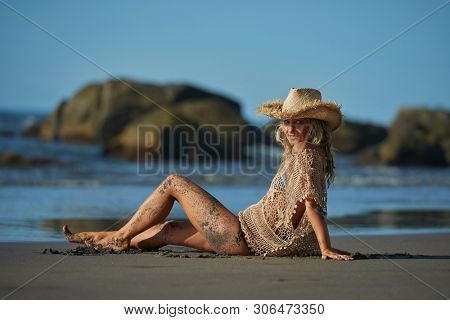 young woman relaxing on the beach in summer day