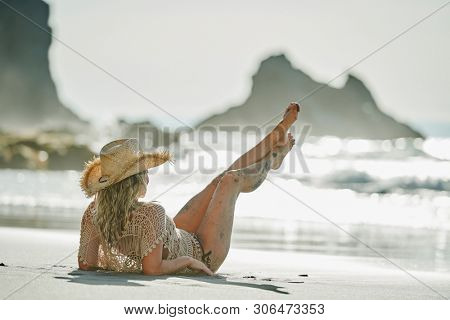 young woman relaxing on the beach in summer day