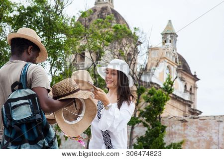 Cartagena De Indias, Colombia - June, 2016: Beautiful Young Woman Buying A Traditional Colombian Hat
