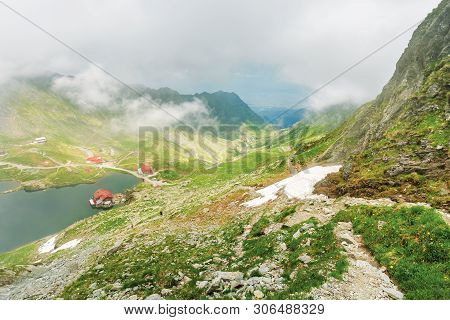 Lake Balea In Dramatic Weather. Beautiful Destination In Fagaras Mountain Of Romania. View Through C