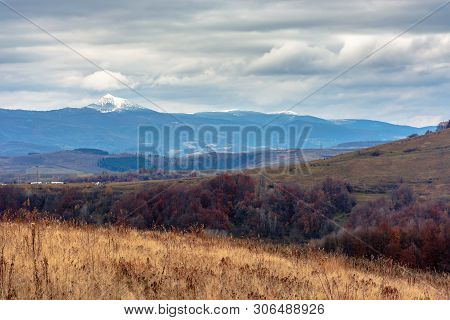 Beautiful Transcarpathian Landscape In November. Overcast Sky Above The Meadow With Weathered Grass 