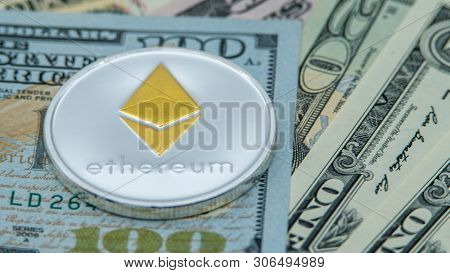 Physical Metal Silver Ethereum Currency Over Diferents Dollars Bills. Eth