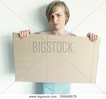 Boy Showing Blank Signboard with Empty Copyspace