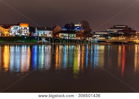 Traetskae Pradmestse Or Trinity Suburb On Svisloch River Bank At Night. Historical Center Of Minsk. 