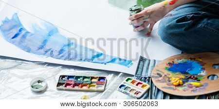 Fine Art Hobby. Cropped Shot Of Artist Sitting On Floor, Creating Artwork Using Watercolor And Acryl