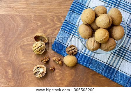 Whole Walnuts And Walnut Kernel Halves Without Shell On A Dark Wooden Table And Checkered Towel, , C