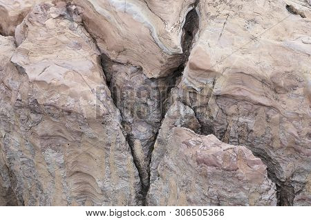 The Rock Is Red With A Fault In America. The Crack In The Stone, A Piece Of A Broken Stone Is Brown