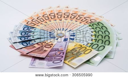 Closeup Of A Coin One Euro With Banknotes Of Different Values. Cash Money