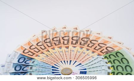 Closeup Of A Coin One Euro With Banknotes Of Different Values. Cash Money