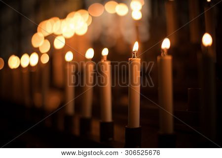 Color Image Of Rows Of Candles Burning In A Church.