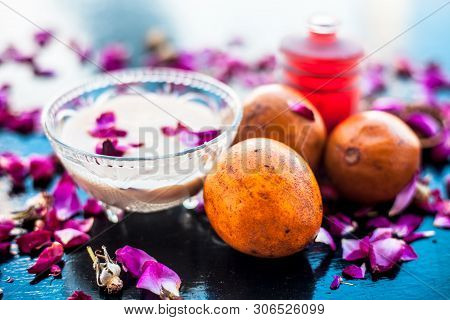 Face Pack For Cheeks On Wooden Surface Consisting Of Sapodilla Or Chikoo Well Mixed With Sandalwood